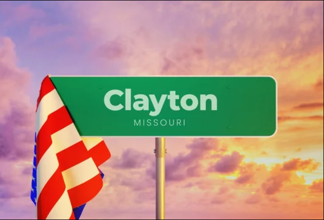 Clayton, Missouri city sign with American flag at sunset