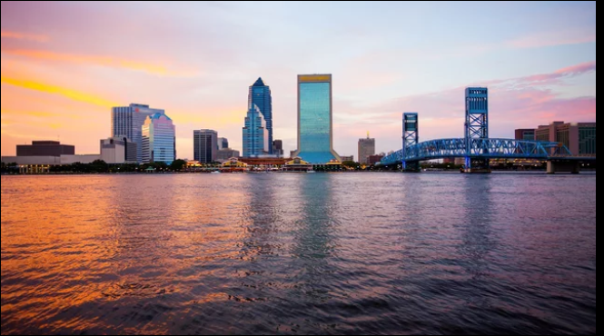 Jacksonville, Florida skyline at sunset with the St. Johns River and Main Street Bridge