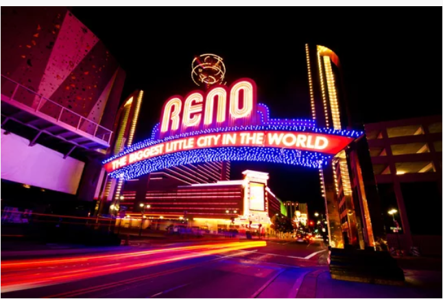 Reno, Nevada downtown skyline with the iconic Reno Arch and Sierra Nevada mountains in the background